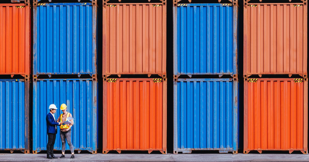 Panoramic of smart creative foreman and engineer woman control loading containers box from cargo freight ship for import export. Logistic, transportation, import and export concept. With copy space.