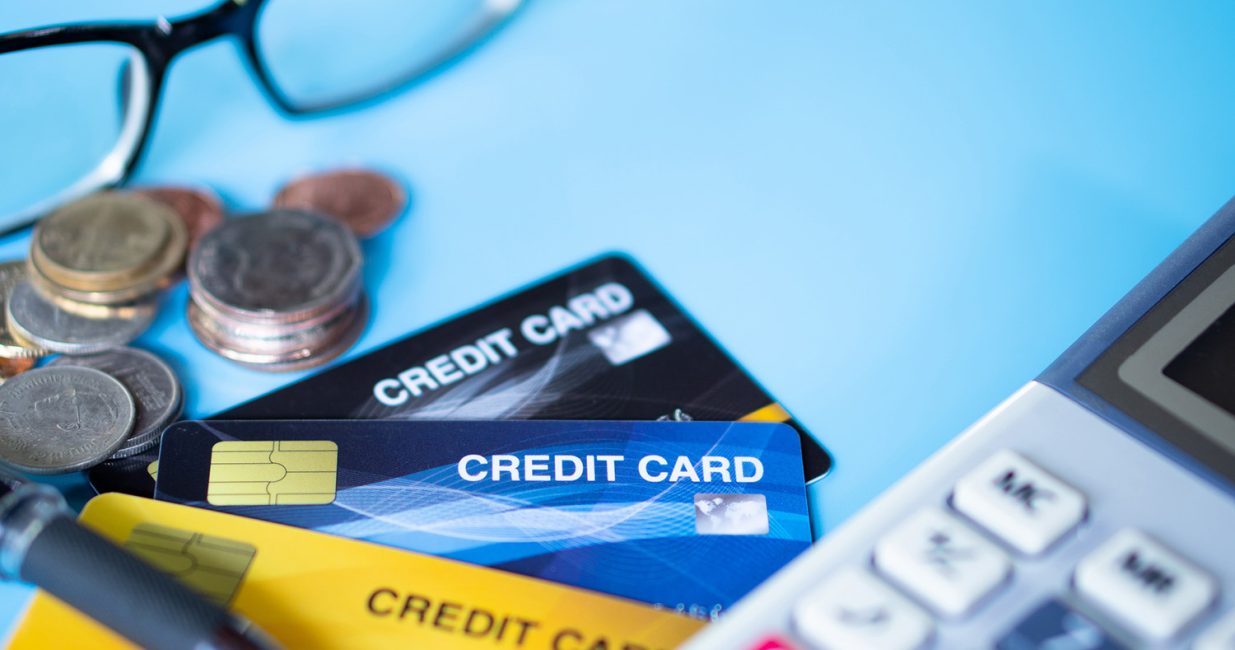 Close up colorful credit card with coin and calculator background