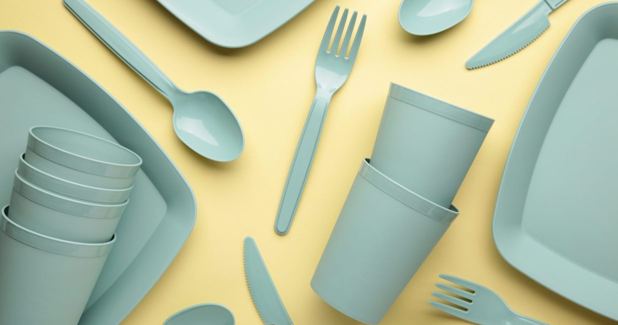 Bright,Plastic,Reusable,Tableware,On,A,Yellow,Background.,Top,View